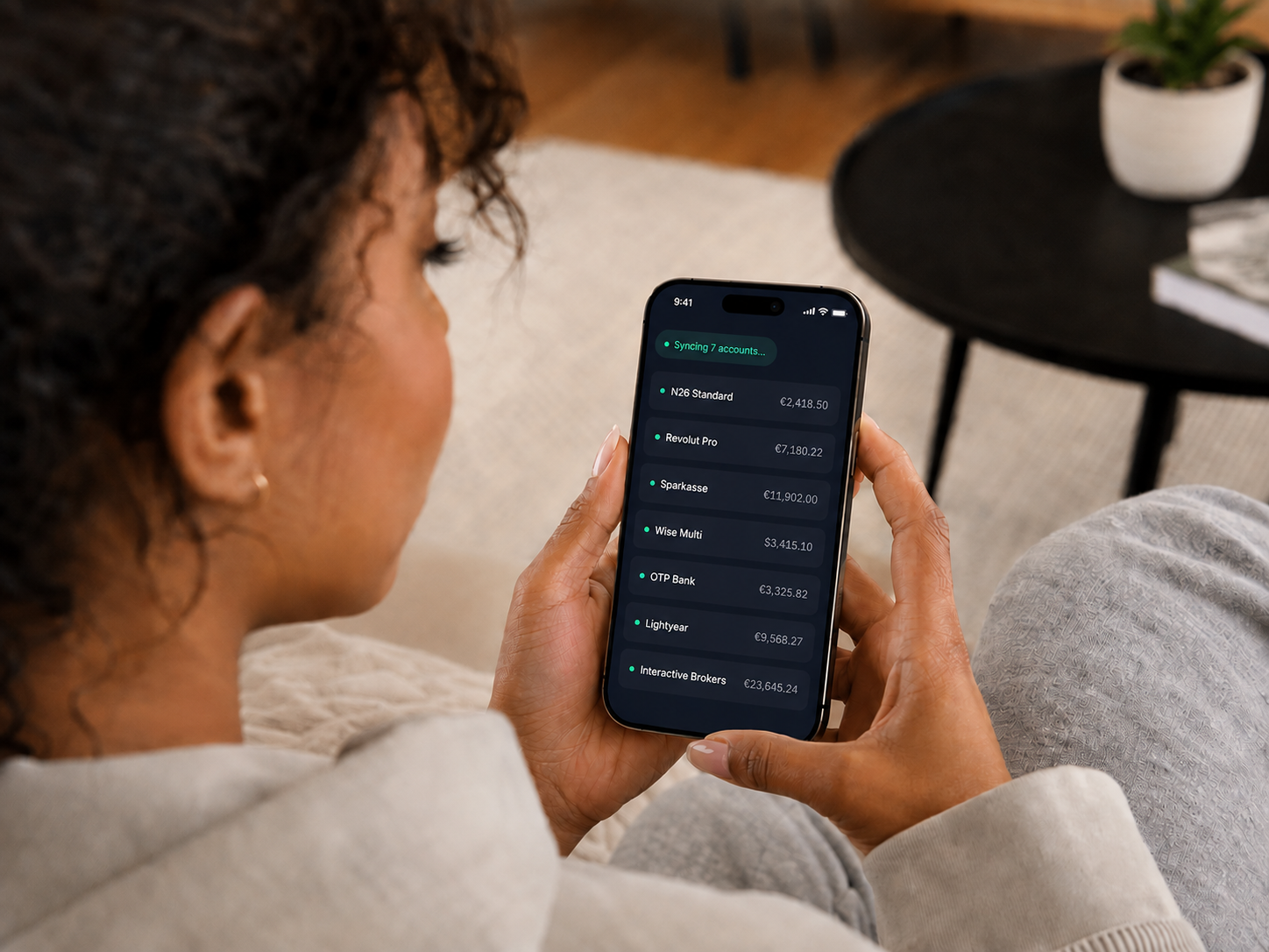 Opvion account sync shown on a phone: multiple connected banks and brokers with live balances.